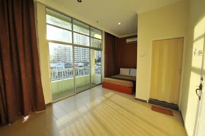 a bedroom with a bed and a large window at Gurney Inn in George Town