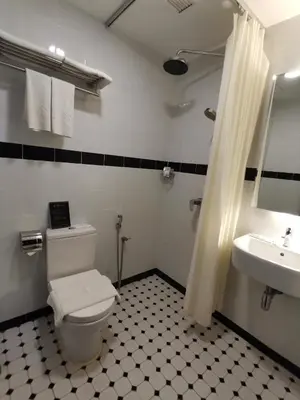 a bathroom with a toilet and a sink at Kimberley Hotel Georgetown in George Town