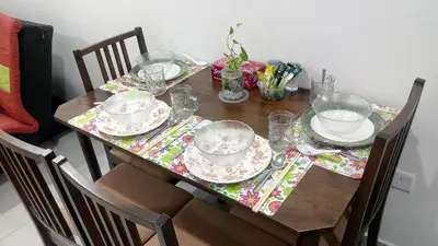 a dining room table with plates and dishes on it at CEO SoHo Suite - biz or holiday 2-5 Pax in Bayan Lepas