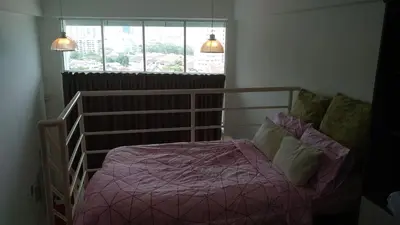 a bedroom with a bed with pink sheets and a window at CEO SoHo Suite - biz or holiday 2-5 Pax in Bayan Lepas