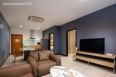a living room with a couch and a flat screen tv at One Pacific Hotel and Serviced Apartments in George Town