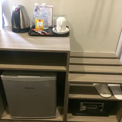 a desk with a table with a computer under it at Gurney Lodge in George Town