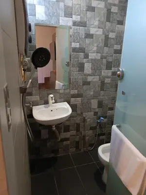 a bathroom with a sink and a toilet at Gurney Lodge in George Town