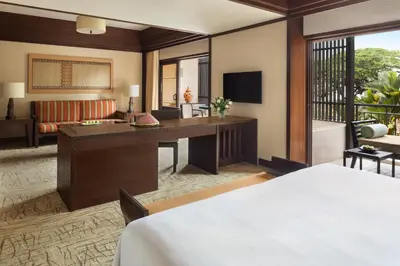a hotel room with a bed and a living room at Shangri-La Rasa Sayang, Penang in Batu Ferringhi