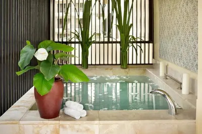 a bathroom with a potted plant and a bath tub at Shangri-La Rasa Sayang, Penang in Batu Ferringhi