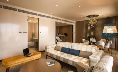 a living room with a couch and a table at JEN Penang Georgetown by Shangri-La in George Town