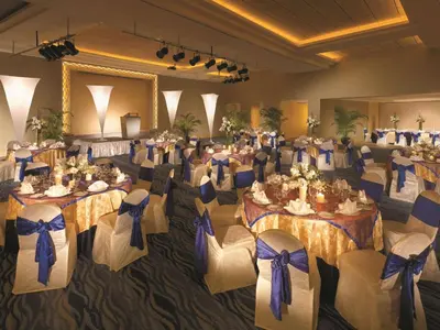 a banquet hall with tables and chairs with purple bows at Shangri-La Golden Sands, Penang in Batu Ferringhi