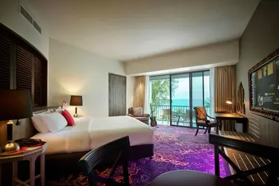 a hotel room with a bed and a large window at Hard Rock Hotel Penang in Batu Ferringhi