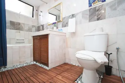 a bathroom with a toilet and a sink and a tub at Century Bay Private Residences in Bayan Lepas
