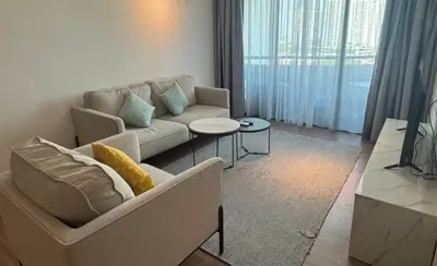 a living room with a couch and a table at Century Bay Private Residences in Bayan Lepas