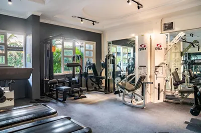 a gym with treadmills and machines in a room at Century Bay Private Residences in Bayan Lepas