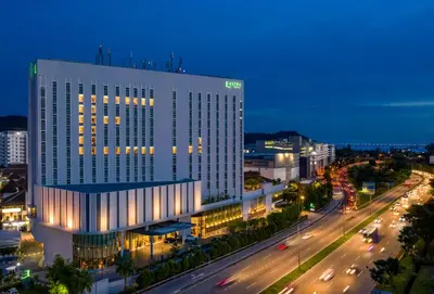 a lit up building in a city at night at Eastin Hotel Penang in Bayan Lepas