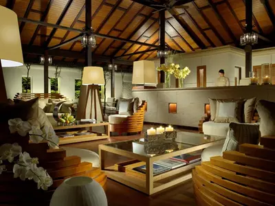 a living room with a couch and a table at Pangkor Laut Resort - Small Luxury Hotels of the World in Pangkor