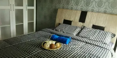 a bed with a plate of food on top of it at Sweet Homestay Penang in Bayan Lepas