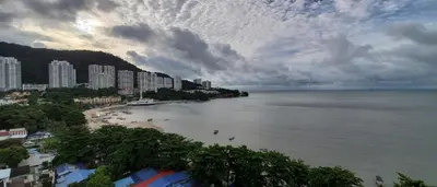 a view of a beach with buildings and the ocean at Leisure Cove Hotel and Apartments in George Town