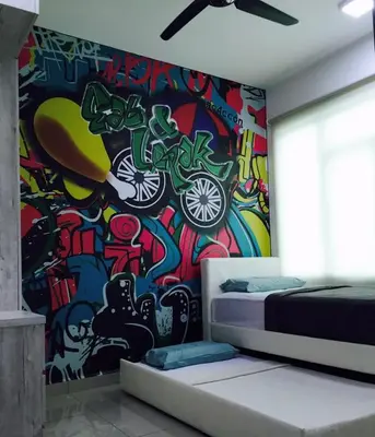 a bedroom with a wall covered in graffiti at The Majestic condo Ipoh in Ipoh