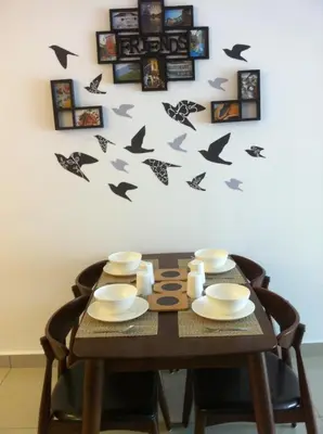a table with birds decals on a wall at The Majestic condo Ipoh in Ipoh
