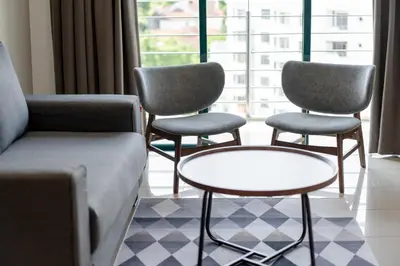 a living room with chairs and a couch and a table at Golden View Serviced Apartments in George Town