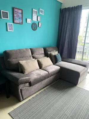 a couch in a living room with a blue wall at Famous night market Cameron Highlands Nearby in Cameron Highlands