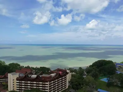a view of the ocean from a building at Green Ocean Seaview Apartment in Batu Ferringhi
