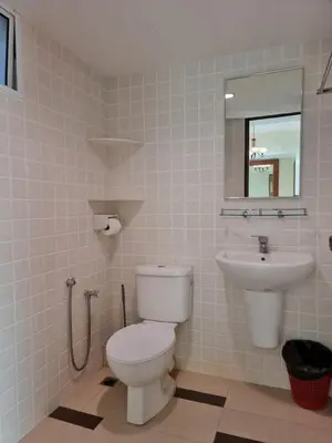 a bathroom with a toilet and a sink at Green Ocean Seaview Apartment in Batu Ferringhi