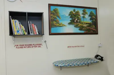 a picture hanging on a wall with a bench at Broadway Budget Hotel in George Town
