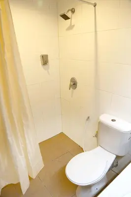 a bathroom with a toilet and a shower at Garden Inn, Penang in George Town
