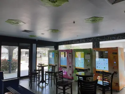 a dining room with tables and chairs and windows at Garden Inn, Penang in George Town