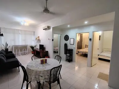 a living room with a table and a couch at Penang Tg Bungah Permai Ria Apartment in Tanjung Bungah