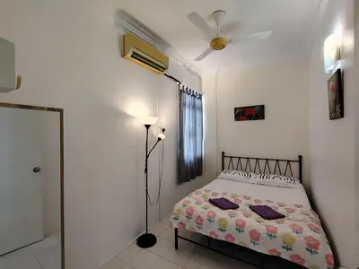 a bedroom with a bed and a ceiling fan at Penang Tg Bungah Permai Ria Apartment in Tanjung Bungah