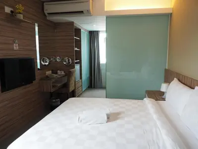 a hotel room with a bed and a television at Mornington Hotel Medan Ipoh in Ipoh