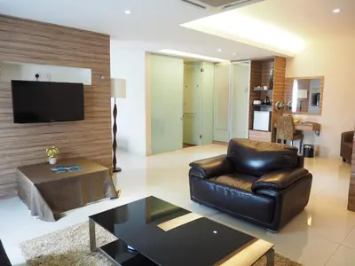 a living room with a leather couch and a coffee table at Mornington Hotel Medan Ipoh in Ipoh