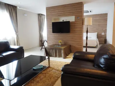 a living room with a couch and a bed at Mornington Hotel Medan Ipoh in Ipoh