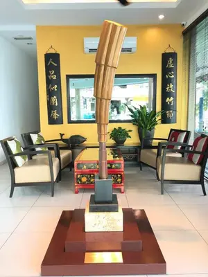 a lobby with chairs and a statue in the middle at Marina Oriental Hotel in Butterworth