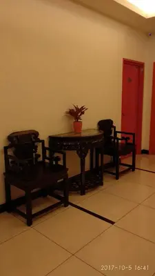 a room with a table and two chairs and a potted plant at Marina Oriental Hotel in Butterworth