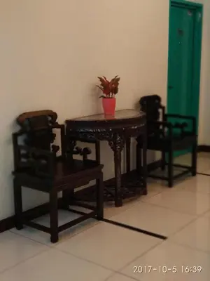 a table and two chairs and a table with a plant on it at Marina Oriental Hotel in Butterworth