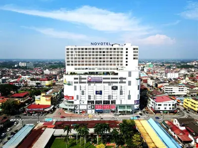a large white building with a novo sign on it at Novotel Taiping in Taiping