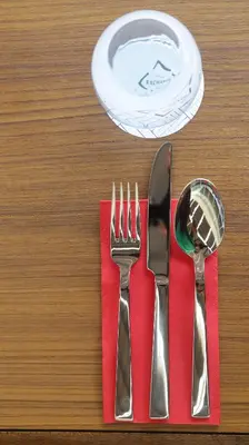a red napkin with fork and knife on a table at Novotel Taiping in Taiping