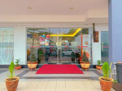 a store front with a red rug in front of a door at Double Happiness Hotel in Seri Manjung