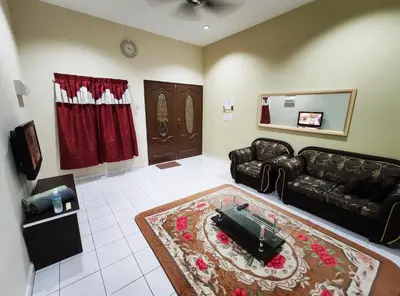 a living room with a couch and a mirror at Homestay selinsing in Simpang Ampat Semanggol