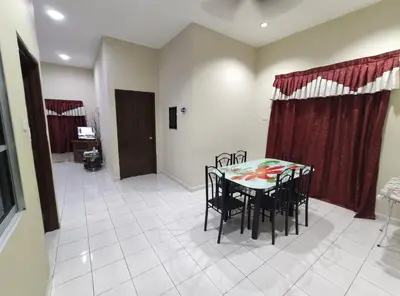 a dining room with a table and chairs at Homestay selinsing in Simpang Ampat Semanggol