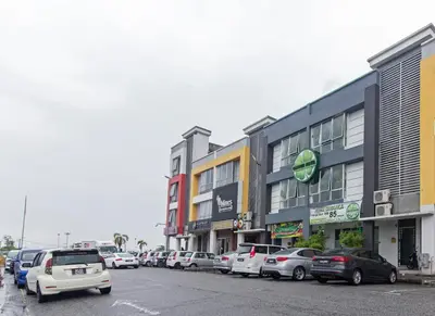 a row of cars parked in front of buildings at Clover Hotel Ipoh in Ipoh