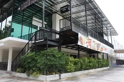 a building with a spiral staircase on the side of it at Tambun Inn Hotel in Ipoh