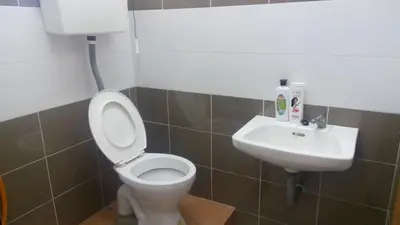 a bathroom with a toilet and a sink at Taiping Valuable Homestay in Taiping