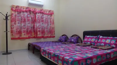 a bedroom with a bed and a window at Taiping Valuable Homestay in Taiping