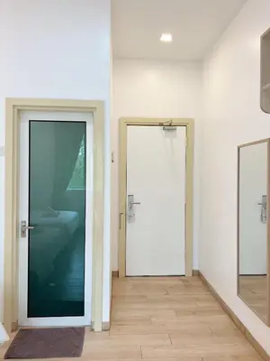 an empty room with a door and a mirror at Vvip Hotel in Hutan Melintang