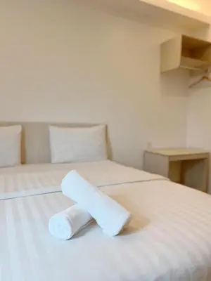 a roll of toilet paper sitting on a bed at Vvip Hotel in Hutan Melintang