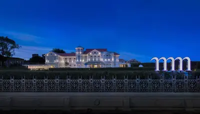 a large white mansion with a fence in front of it at Macalister Mansion, a Member of Design Hotels in George Town