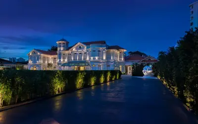 a large white mansion with a long driveway at Macalister Mansion, a Member of Design Hotels in George Town