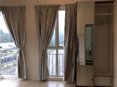 a room with a large window with curtains at Cameron New Apartment @ Golden Hill in Cameron Highlands